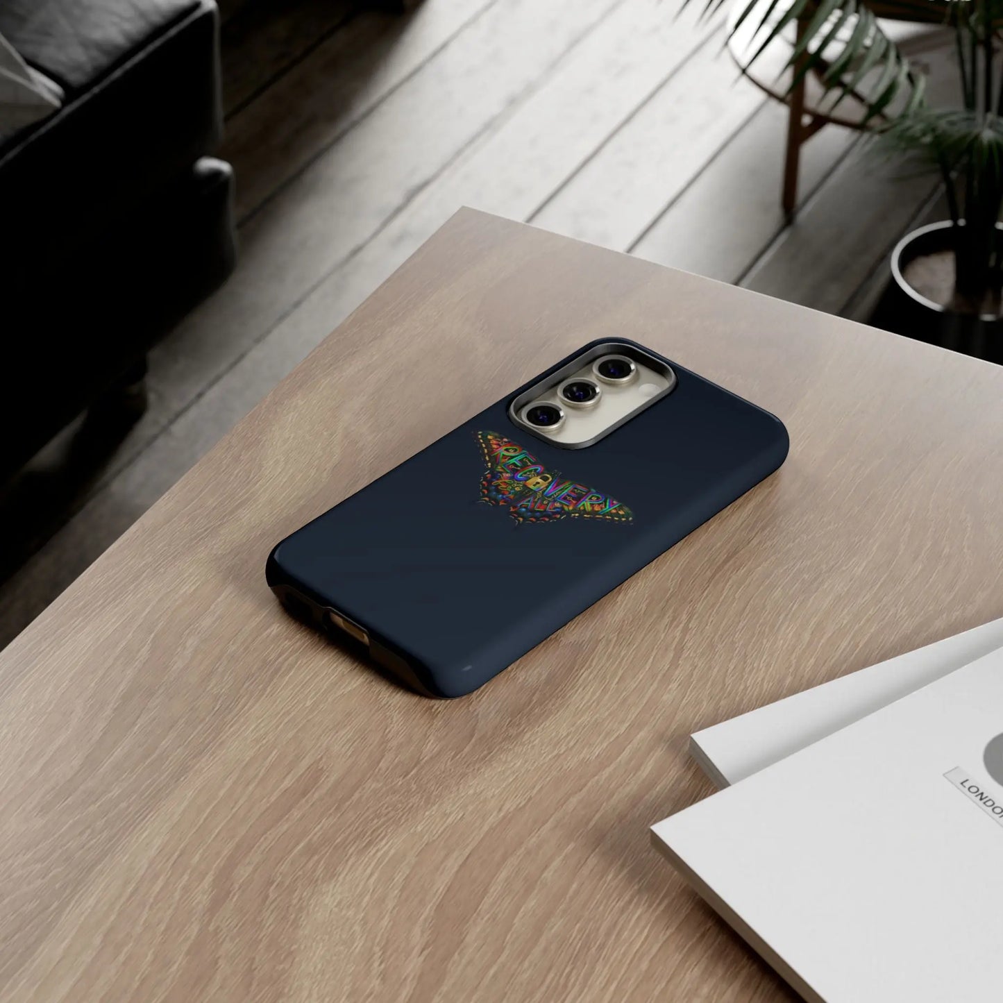 Phone case with black marble pattern on a wooden surface