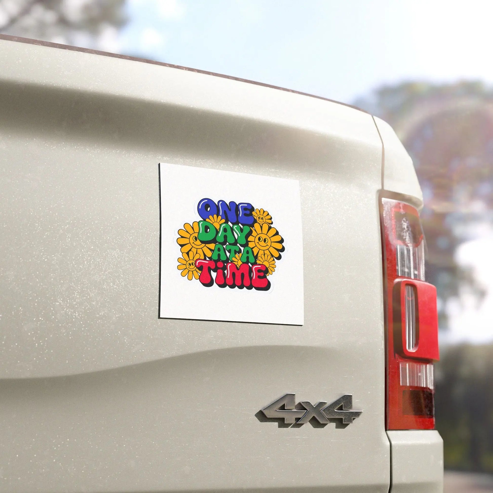 Colorful 'One Day at a Time' sticker on a 4x4 vehicle's rear